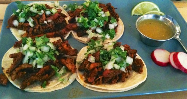 My hands are trembling too much to get a sharp photo of these wonderful al pastor tacos at Tres Carnales Taqueria