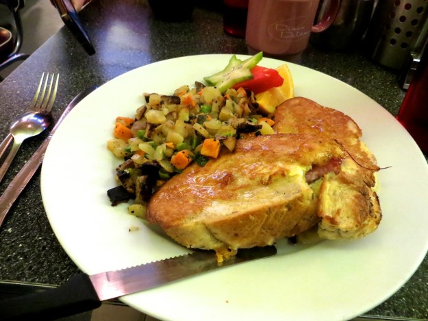 Ham and Gouda are squeezed into this rosemary sourdough French toast at Diner Deluxe