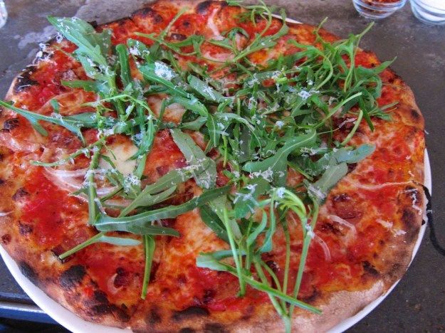 The toppings are simple but fresh in this bacon, mozza and argula pizza