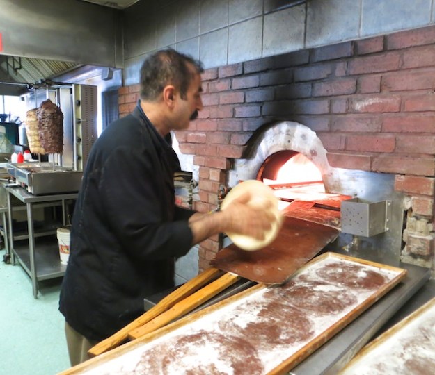 Cooked-to-order pitas heading into the oven at Edmonton's Al Salam Bakery Deli & Restaurant