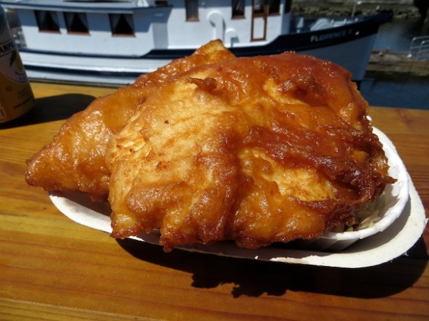 There are some fries buried beneath this huge piece of halibut