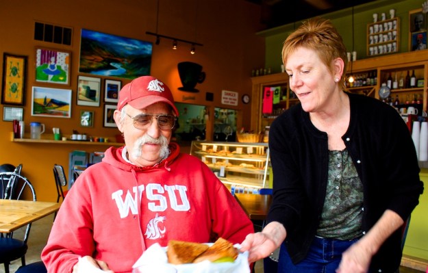 Co-owner Tiana Gregg delivers a fresh-made sandwich